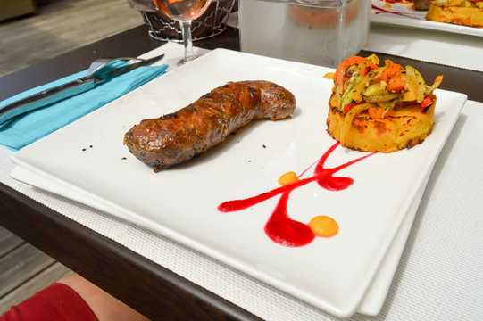 Andouillette served with a potato cake