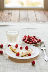 Cottage cheese casserole with sugar powder and a glass of milk