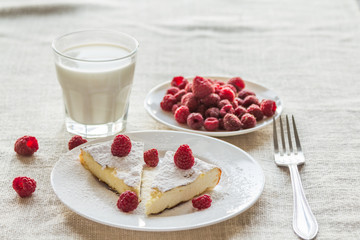 Cottage cheese casserole with sugar powder and a glass of milk