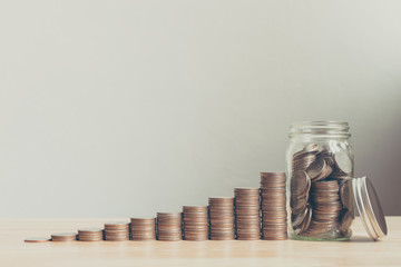 Coin in glass bottle with money stack step up growing growth saving money, Concept financial...