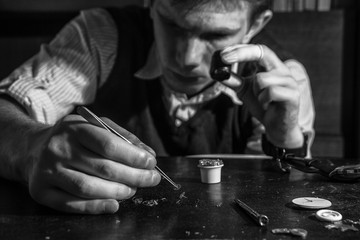 The watchmaker is repairing the mechanical watches in his workshop
