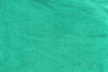 Green Denim Textile Texture Close-up. Macro Snapshot of Tissue Structure