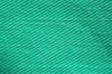 Green Denim Textile Texture Close-up. Macro Snapshot of Tissue Structure