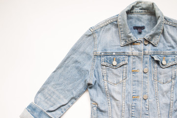 Flat lay part of jeans jacket on white background with copy space