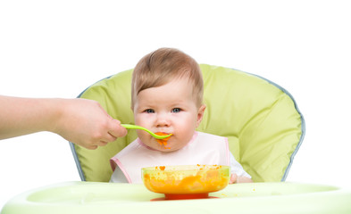 Mother feeding happy baby with a spoon. isolated on white background