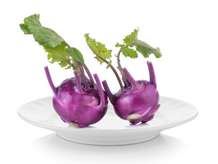 Purple kohlrabi in white plate on white background