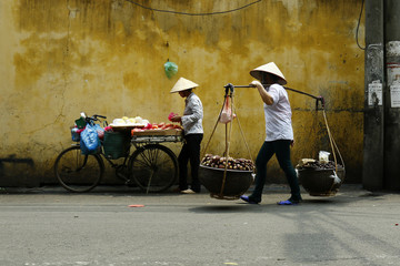 street seller with bicycle in the street of hanoi