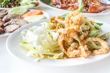 Lao papaya salad on white dish for lunch or dinner.