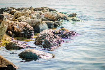 Blue sea and sharp rocks that surround it