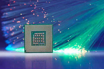 Powerful Computer Processor On Background With Fiber Optics And Reflections On White  Lighted Table