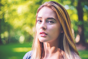 Portrait of a young woman outside on a summer day