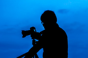 silhouette of man take a photo