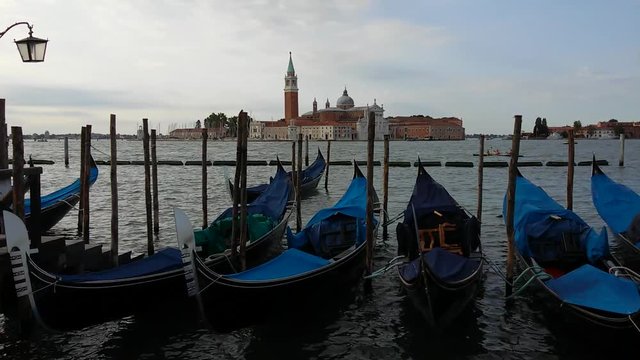 Gondolas on Venice Grand Channel floating on wawing water of lagoon with sound of sea view
