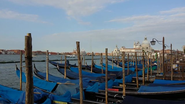 Gondolas on Venice Grand Channel floating on wawing water of lagoon with sound of sea view