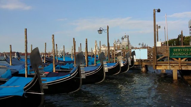 Gondolas on Venice Grand Channel floating on wawing water of lagoon with sound of sea view