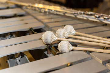 xylophone, music and chromatic instrument concept - closeup on wooden bars with four mallets,...