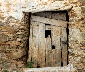 Old wooden door on a stone wall
