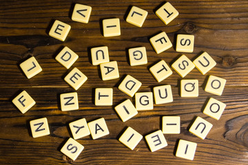 Many letters on wooden background