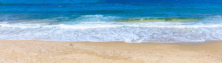 Fototapeta na wymiar Sandy beach and blue sea background