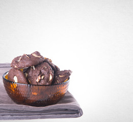 Cookies or Almonds chocolate cookies on background.