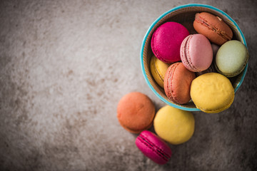 colorful macaroon cookies on concrete background