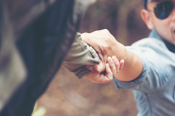The man gives helping hand outstretched for salvation