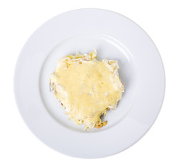 Roasted pork steak baked with cheese .