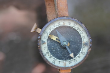 Old Military compass hanging on leather strap.  