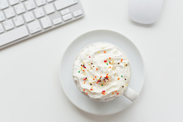 Tasty dessert with colorful sprinkles in porcelain cup