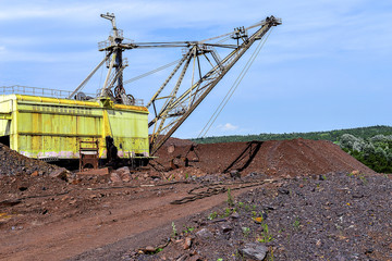 Excavator machine at excavation earthmoving work in quarry