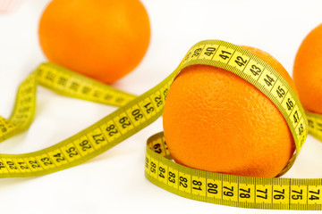 ripe oranges and tape measure