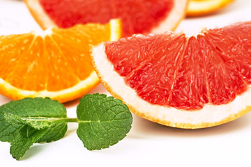Fototapeta na wymiar orange slices and grapefruit and mint leaves