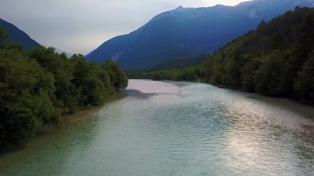 4K. Flight and takeoff above Soca river in Slovenia at sunset. Julian Alps, Soca Valley, Bovec district.
