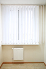 Window with white jalousie in modern apartment