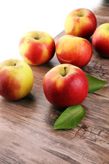 Ripe red apples on wooden background summer concept