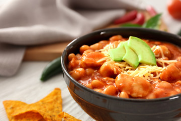 Bowl with delicious turkey chili on table