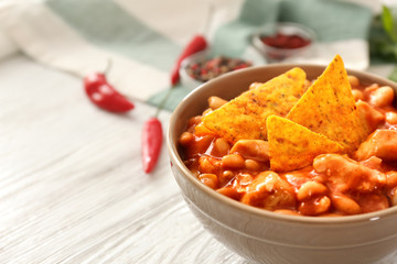 Bowl with delicious turkey chili on table