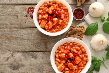 Two bowls with delicious chili turkey on wooden background