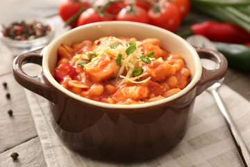 Casserole with delicious chili turkey on napkin
