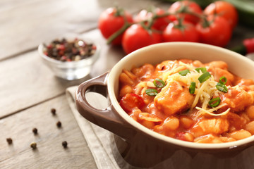 Casserole with delicious chili turkey on napkin