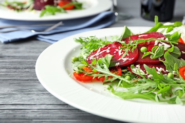 Plate with useful beet salad on table