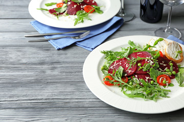 Plate with useful beet salad on wooden background