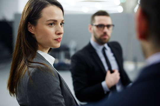 Businesswoman listening to one of colleagues during discussion