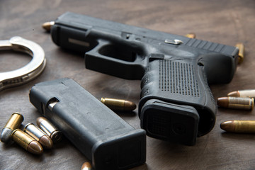 Obraz premium Gun with ammunition on dark background. 