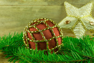 Christmas decoration - christmas balls and fir branch on a rustic board
