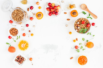 Breakfast with muesli, fruits, berries, nuts on white background. Healthy food concept. Flat lay, top view, copy space