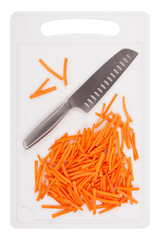Kitchen knife and sliced carrots on a plastic cutting board closeup, top view