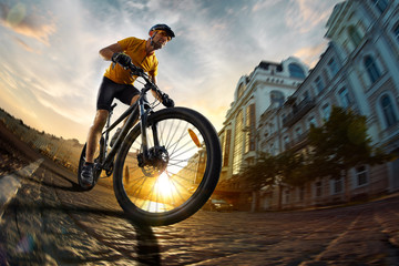 Bicycle rider  cycle in city street fish eye view sunset