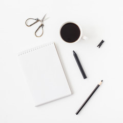 Workspace with notebook, cup of coffee, pencils. Business concept. Flat lay, top view, square