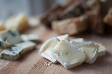 Cheese brie and bread on wooden plate